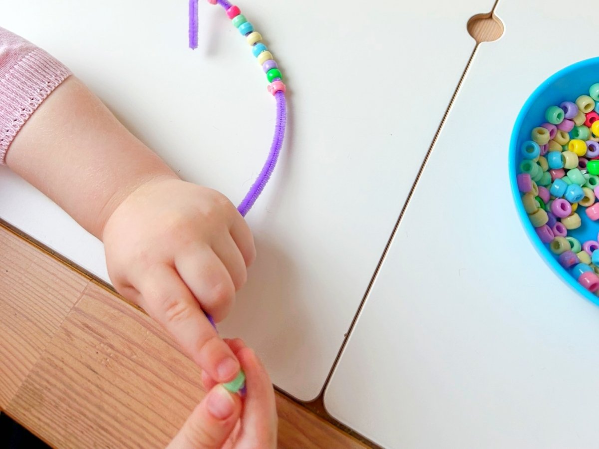 Thread beads onto a pipe cleaner