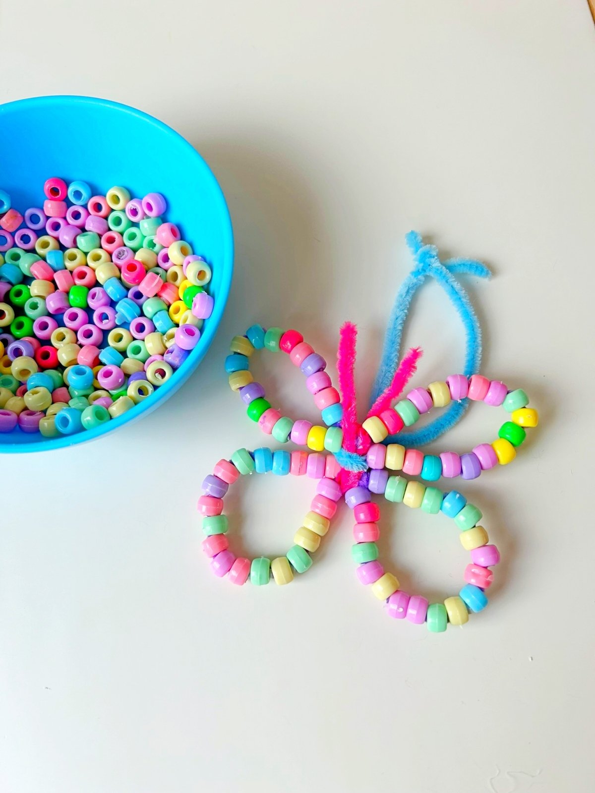 thread beads to make a butterfly for a fun spring activity for kids