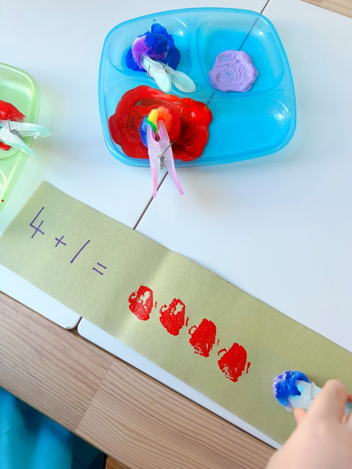 use pom poms and paint for a hands-on and visual approach to early math