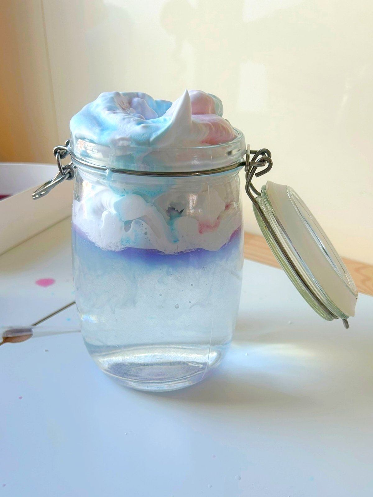 observe coloured water seeping through the shaving foam cloud -  Spring activities for kids