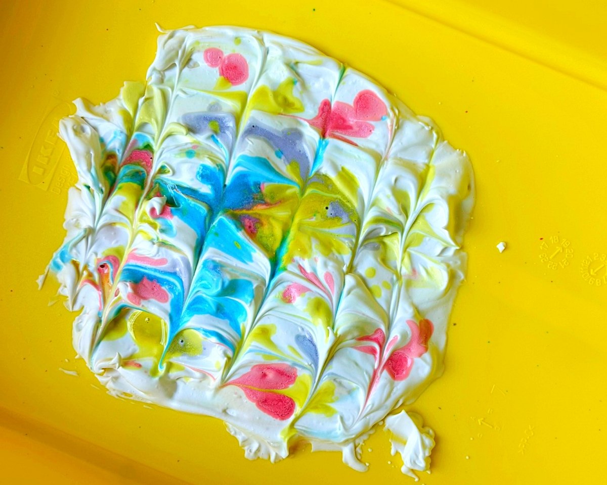 swirl the shaving foam and paint to create a marbled effect