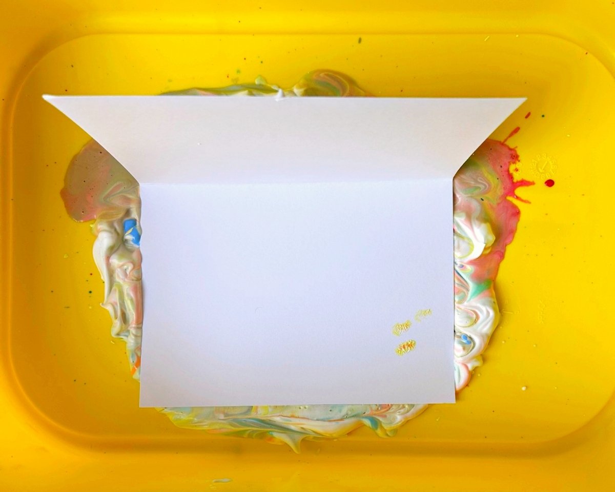 place a piece of card on the shaving foam and paint